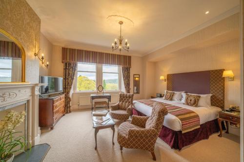 a hotel room with a bed and a television at Lindeth Fell Country House in Bowness-on-Windermere