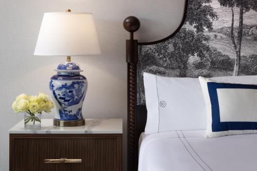 una lampada blu e bianca su un comodino accanto a un letto di Omni Charlottesville Hotel a Charlottesville