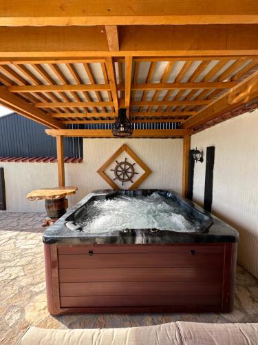 een hot tub onder een houten dak bij Vila Impresija Fruska gora in Novi Sad