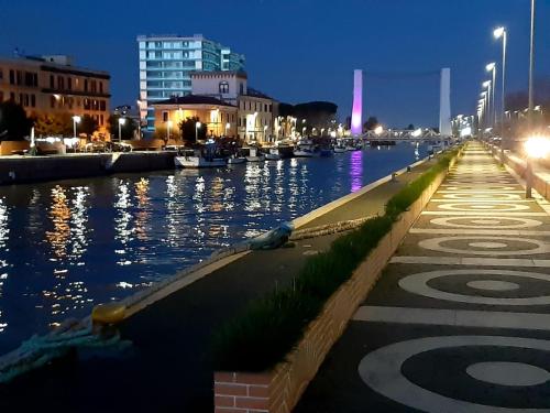 a view of a river at night with buildings at Sweet Home FCO Airport Roma in Fiumicino