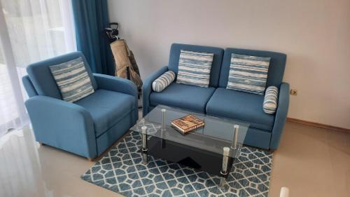 a living room with two blue chairs and a coffee table at Luxury Lighthouse Golf Villa in Balchik