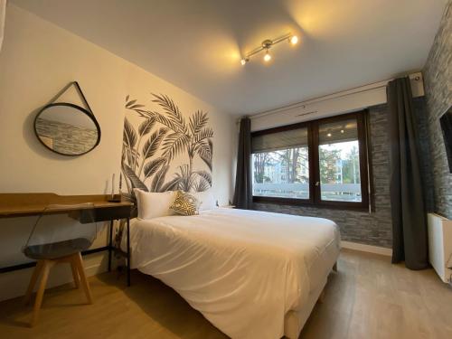 Studios & chambres aux portes de Genève में एक कमरे में एक या कई बेड