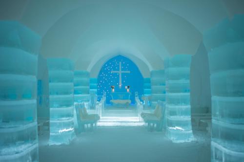 an image of a blue church with a cross on the altar at Sorrisniva Igloo Hotel in Alta