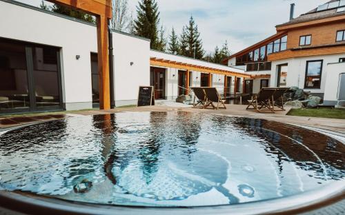 a swimming pool in the backyard of a house at Hotel Horal in Rožnov pod Radhoštěm