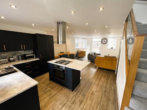 an open kitchen and living room with a staircase at Jollys in Sandown