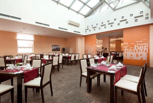 a restaurant with tables and chairs in a room at Clarion Congress Hotel Ostrava in Ostrava