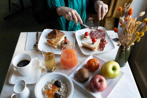 einen Tisch mit Frühstücksteller darauf in der Unterkunft Hôtel Escurial - Centre Gare in Metz