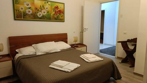 a bedroom with a bed with two towels on it at Rome Apartment D'Amata in Ciampino