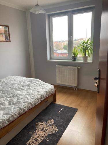 Una cama o camas en una habitación de Apartament nad rzeką na Mazurach