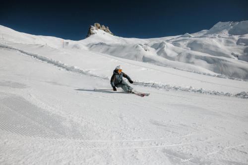 una persona sta sciando giù da una montagna innevata di Berghotel Engstligenalp ad Adelboden