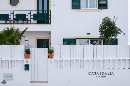 a white building with a white fence and plants at Casa Idalia Boutique Hotel in Comporta