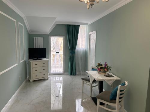 a living room with a table and a television at Casa Avram in Suceviţa