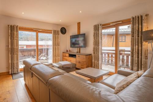 A television and/or entertainment centre at Grand Paradis- Modern 3 bedroom apartment with spectacular views