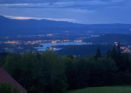 - une vue sur la ville et le lac la nuit dans l'établissement Faakersee Seahouse mit Privat Strand -Only Sa-Sa, à Faak am See