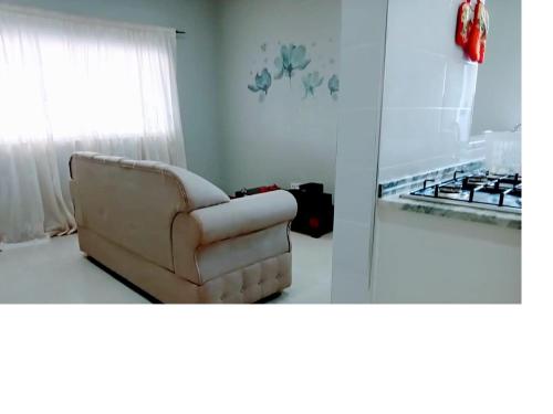 a couch sitting in a living room next to a stove at Apartamento T1 in Praia