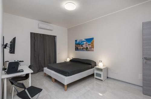 a bedroom with a bed and a tv in it at Travelershome Ciampino Airport GuestHouse 600m to Airport in Ciampino