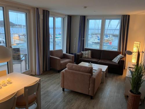 sala de estar con sofá, sillas y mesa en Apartmenthaus Hafenspitze Ap 10 - "Borbyblick" - Blickrichtung Hafen und offene See - a72335, en Eckernförde