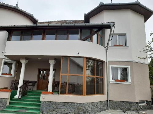 a house with large glass doors on it at Pensiunea Crown Royal in Alba Iulia