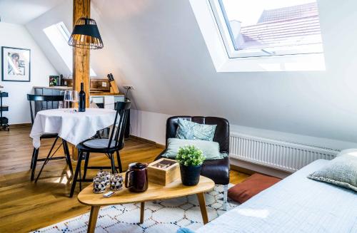 a room with a bed and a table and a chair at Besighomes Apartment Loft in Besigheim