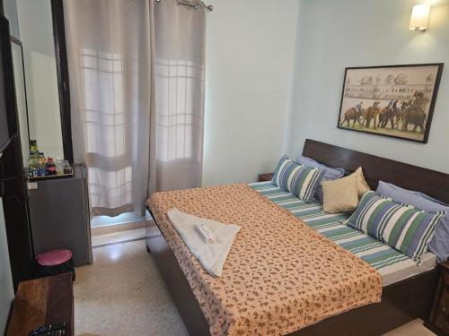 een kleine slaapkamer met een bed en bij Sky Bloom Luxury Homestay in New Delhi