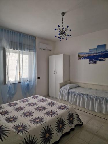 a bedroom with two beds and a chandelier at Agriturismo Fuoco D'Amalfi Villa Iazzetta in Amalfi