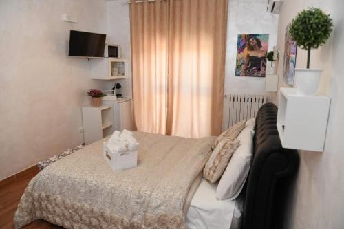 a bedroom with a bed with a box on it at Casa Donna di Cuori in Fiumicino