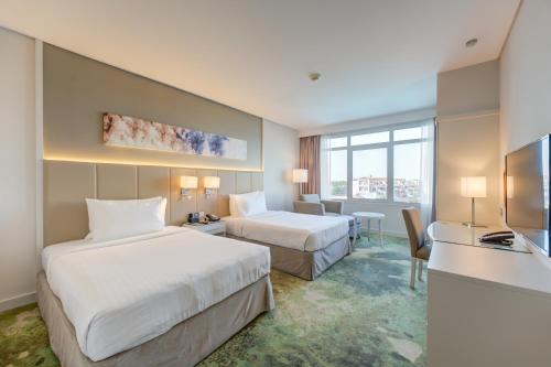 Tempat tidur dalam kamar di Copthorne Lakeview Hotel Dubai, Green Community