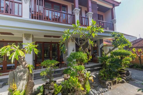 a building with trees and plants in front of it at Donahome in Sanur