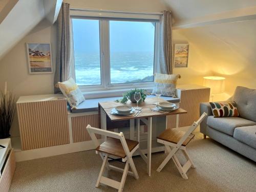 uma sala de estar com uma mesa e uma janela em Pier View Retreat - Close to Beach - Sea Views With Parking em Bournemouth