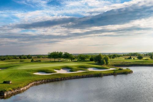 a view of a golf course with a lake at Luxury Lighthouse Golf Villa in Balchik