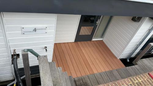 an open door of a house with a wooden floor at Woonboot 4 Harderwijk in Harderwijk