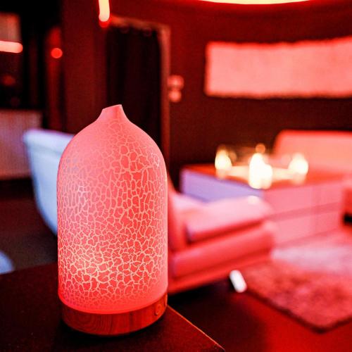 a red vase sitting on top of a table at cosy corner waterloo in Waterloo