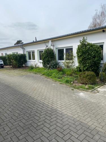 a house with a brick driveway in front of it at M&R Hostel in Rostock