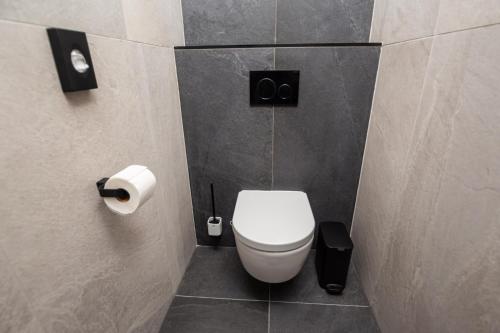 a bathroom with a white toilet in a stall at Hotel Kras in Jedovnice