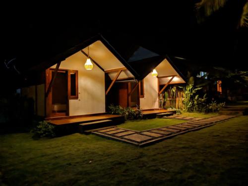 a small house at night with lights on it at Waroeng Senaru in Senaru