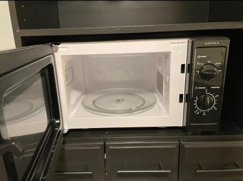 a microwave oven sitting on top of a counter at Aurora dream in Skjervøy