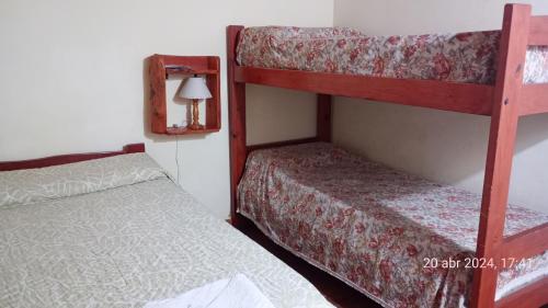 A bed or beds in a room at Hostería El Alemán