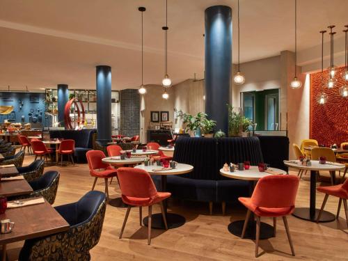 a dining room with tables and chairs and a restaurant at Sofitel Brussels Europe in Brussels