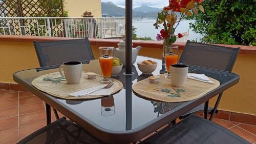 a table with two plates of food and drinks at Il Girasole in Gaeta