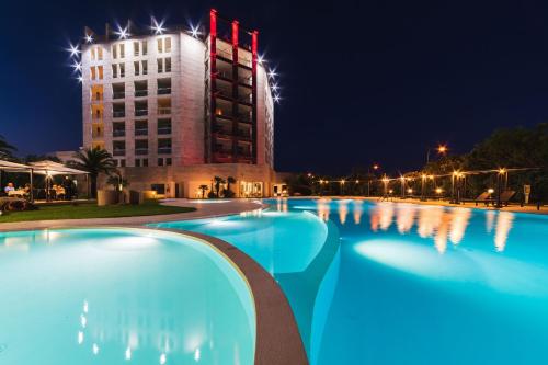 a hotel with a pool at night at Delta Hotels by Marriott Olbia Sardinia in Olbia