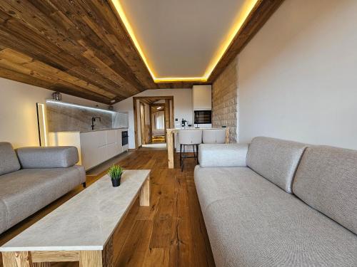 a living room with a couch and a table at Magnifique attique avec vue sur le lac de la Moubra in Crans-Montana