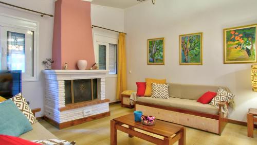 a living room with a couch and a fireplace at Villa Vivere in Corfu Town