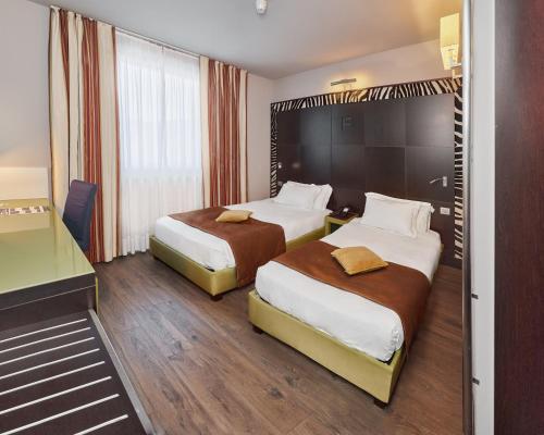 Katil atau katil-katil dalam bilik di First Hotel Malpensa