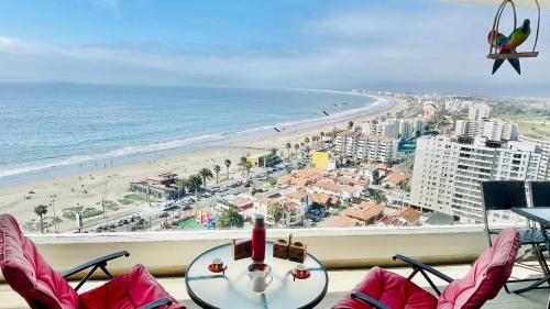 a room with a view of a beach and the ocean at La Choza VIP Roja in Coquimbo