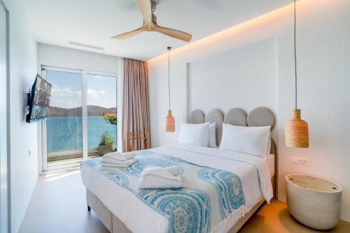 A bed or beds in a room at Ocean Rythm Elounda Suite