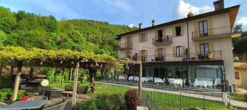 a large building with a garden in front of it at Hotel Il Perlo in Bellagio