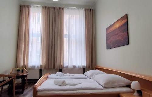 a hotel room with a bed in front of a window at Pension I in Berlin