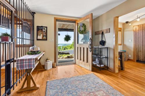 a home with aoyer with a staircase and a door at Roadrunner Inn and Log Cabins in Eureka Springs