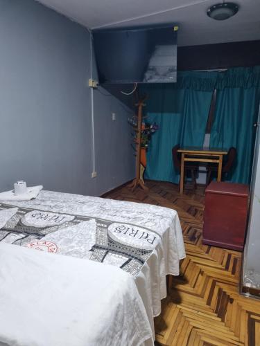 A bed or beds in a room at Hostal Chavin