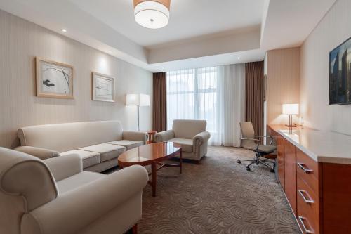 a living room with a couch and a table at Sheraton Changsha Hotel in Changsha